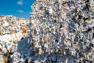 Shallow focus of the front of a fresh shredded bale of business papers and used stationary. Shown...