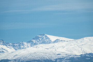Fototapeta na wymiar View of the snowy Mulhacen in Sierra Nevada; It is the highest peak in the Iberian Peninsula