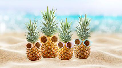 Pineapples in sunglasses on the beach. Tourism. White sand on the seashore. Tropical summer vacation. Family vacation. Travel.