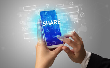 Hand using smartphone with social media concept