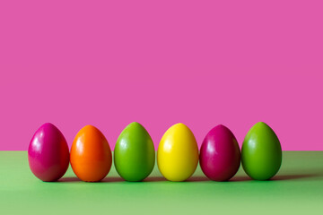colorful easter eggs on a pink background spring