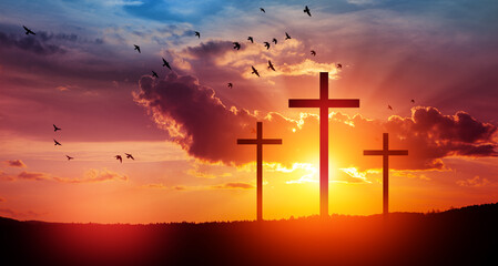 Christian cross on hill outdoors at sunrise. Resurrection of Jesus. Concept photo.