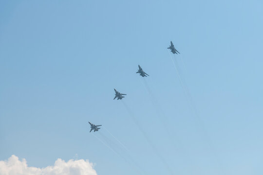 Russia, Sevastopol - July 21, 2021: Group of supersonic interceptor aircrafts Mikoyan MiG-31 (NATO reporting name: Foxhound) flies in the sky. Rehearsal of Russian Navy Day parade.