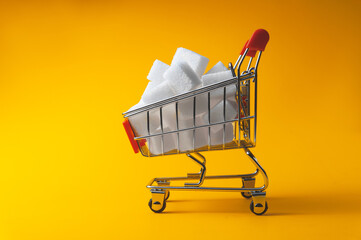 Sugar in pieces lies in the grocery basket. The concept of the value of sugar as a food product.