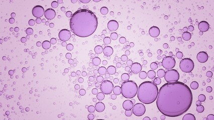 Macro shot of violet different sized transparent oil drops and bubbles floating clear fluid on pale purple background | Abstract skin care product ingredients concept
