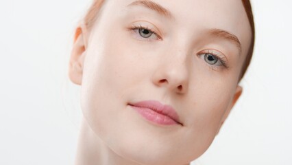 Obraz na płótnie Canvas Big close-up beauty portrait of young positive ginger Caucasian woman | Beauty care commercial concept