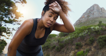 The path to a healthier lifestyle doesnt come without challenges. Shot of a sporty young woman taking a break while exercising outdoors.