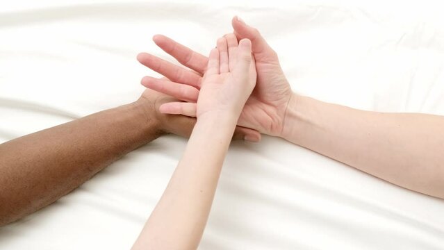 Hands close up multiracial family love african man, caucasian woman and child touch each other on white.