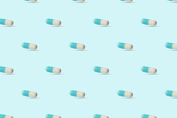 Capsules, pills on a blue background. Seamless pattern for the background. Medical pharmacy flat lay design for presentation packaging website flyer cover business cards.