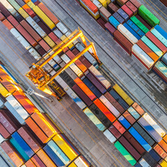 Aerial view of shipping container port terminal. Colourful pattern of containers in harbor....