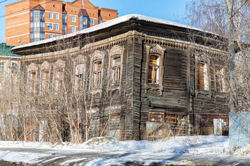 Exterior view of an abandoned wooden house, boarded up windows, in city . poverty and horror...