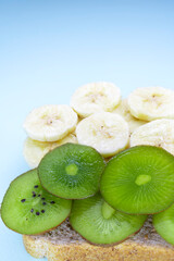 Naklejka na ściany i meble Tropical fruits. Delicious sandwich. Bananas and kiwi