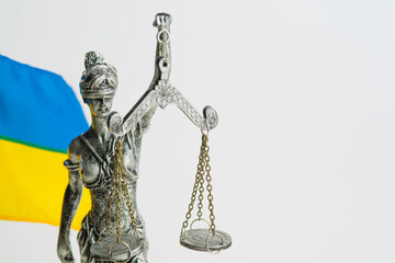 Goddess of justice Themis and the state flag of Ukraine on a white background. There is free space to insert. There are no people in the photo. Freedom, independence, justice, Constitution Day.