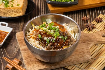 Tasty dry pasta noodle in a steel bowl isolated on wooden board side view on table taiwan food