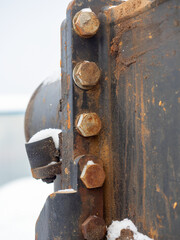 Close-up of the metal bolts on the joint subjected to corrosion