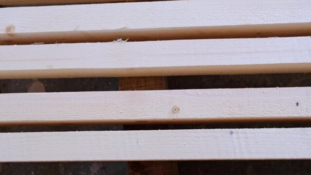 Sawn boards lie on the floor parallel to each other for drying. Preparation for the installation of an eco-friendly wooden floor in a rural house. Lumber from the sawmill
