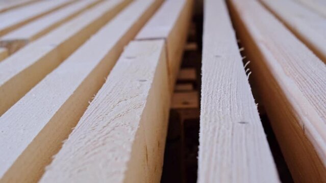 Sawn boards lie on the floor parallel to each other for drying. Preparation for the installation of an eco-friendly wooden floor in a rural house. Lumber from the sawmill