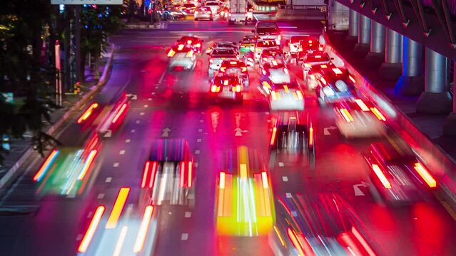 Night traffic jam Timelapse Bangkok, Thailand. Rush hour in downtown, motion of car tail lights, red stop signals vehicles moving before, Cityscape. Urban Transport lifestyle No logos and trademarks