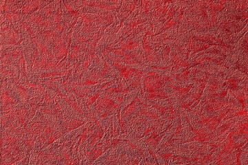 Red background with abstract pattern of various shapes, fabric and paper texture