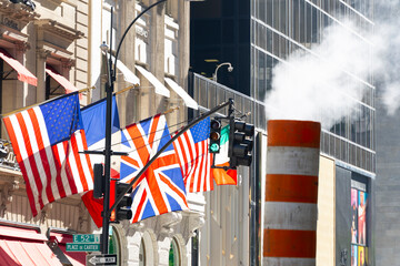 National flags flutter at storefront of the Cartier store and Versace store on the Fifth Avenue in Midtown Manhattan on October 14, 2021 in New York City NY USA.
