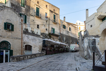 Fototapeta na wymiar Cobblestone street in the Sassi di Matera a historic district in the city of Matera. Basilicata. Italy