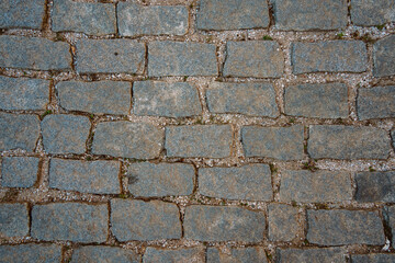 Old stone floor background. Macro shot of the street bricks. Background texture with old dirty and vintage style pattern