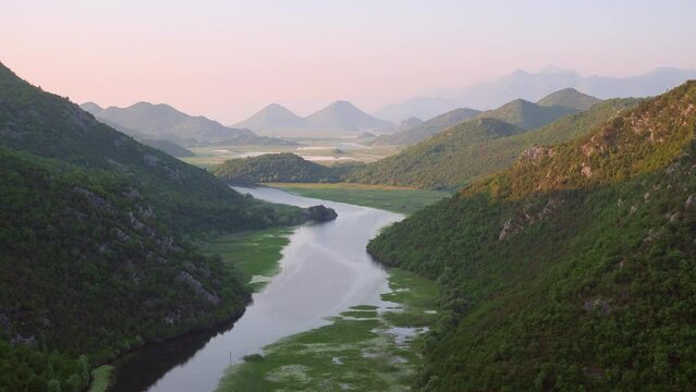 Great footage overlooking the bend of Rijeka Crnojevica around the green mountain peaks.