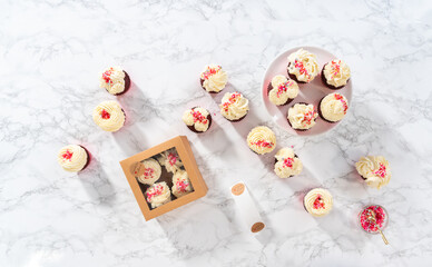 Fototapeta na wymiar Red Velvet Cupcakes with White Chocolate Ganache Frosting