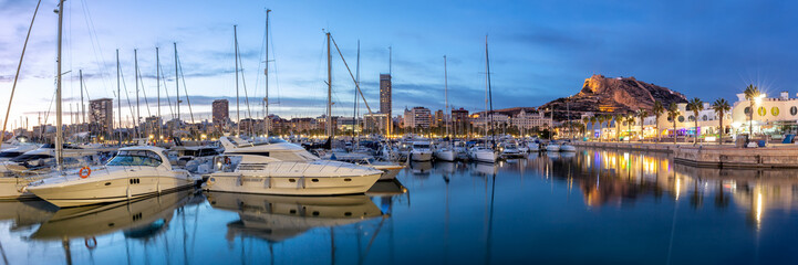 Alicante Port d'Alacant marina with boats and view of castle Castillo twilight travel traveling...
