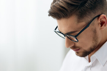 handsome businessman in a white shirt sits at a computer work documentation technologies