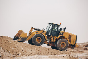 Dozer, excavator, and road rollers working on the mud site