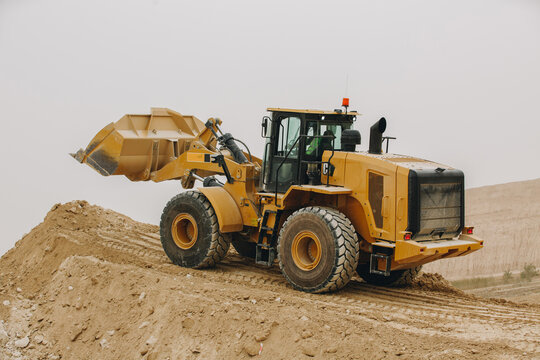 Dozer, excavator, and road rollers working on the mud site