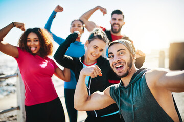 Our hard work deserves a selfie. Cropped shot of a fitness group taking a selfie while out for a run on the promenade.