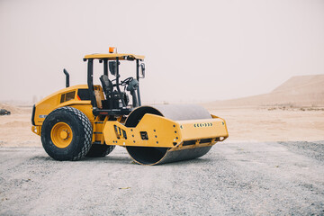 Fototapeta na wymiar Dozer, excavator, and road rollers working on the mud site