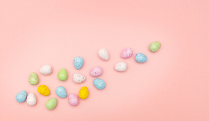 Fototapeta na wymiar Colorful Easter eggs on a pink background