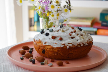 A bouquet of daisies, homemade cakes for Easter on the table