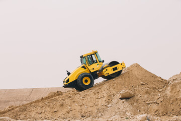 Dozer, excavator, and road rollers working on the mud site