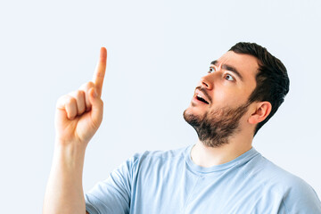 surprised young bearded handsome man wearing yellow hat cap standing over isolated white background...