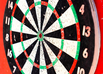 The target of the game of darts on a red background. Concept of success and goal achievement