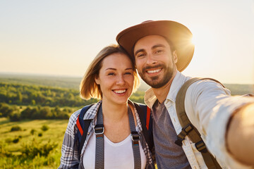 Close-up of young couple taking selfie during hike on summer vacation