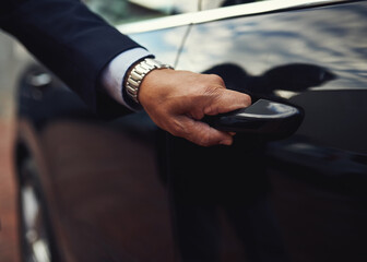 Travel in top class style. Cropped shot of a businessman opening a car door.