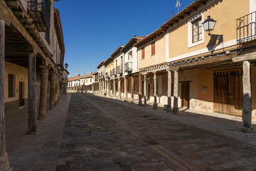 Fototapeta na wymiar Streets with a traditional Castilian architecture with its houses with arcades in Ampudia, Palencia, Castilla y León, Spain.
