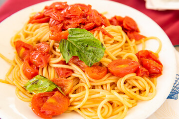delicious spaghetti with tomato sauce in a white dish