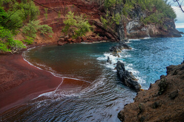 Kaihalulu Red Sand Beach on the Road to Hana in the East of Maui island in Hawaii, United States