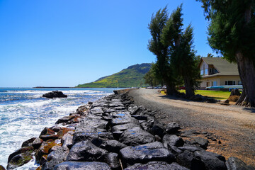 Lava rock breakwater on Kalapaki Beach on the South Shore of Kauai island in Lihue, Hawaii, United...