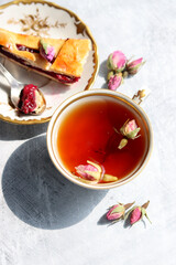 Sweet berries pie, cup of tea, small silver spoon and jug of milk on a table. Beautiful weekend breakfast on a table. 