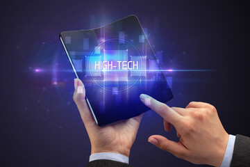 Businessman holding a foldable smartphone