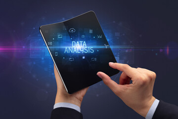 Businessman holding a foldable smartphone, security concept