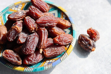Red dates close up photo. Healthy sweets on a plate. Balanced diet concept. 