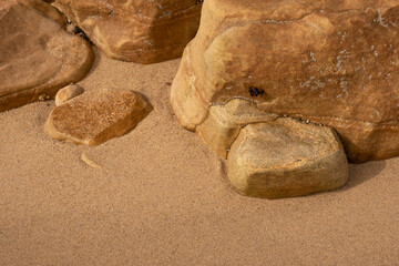 Fototapeta na wymiar Stones in the sand on the ocean beach